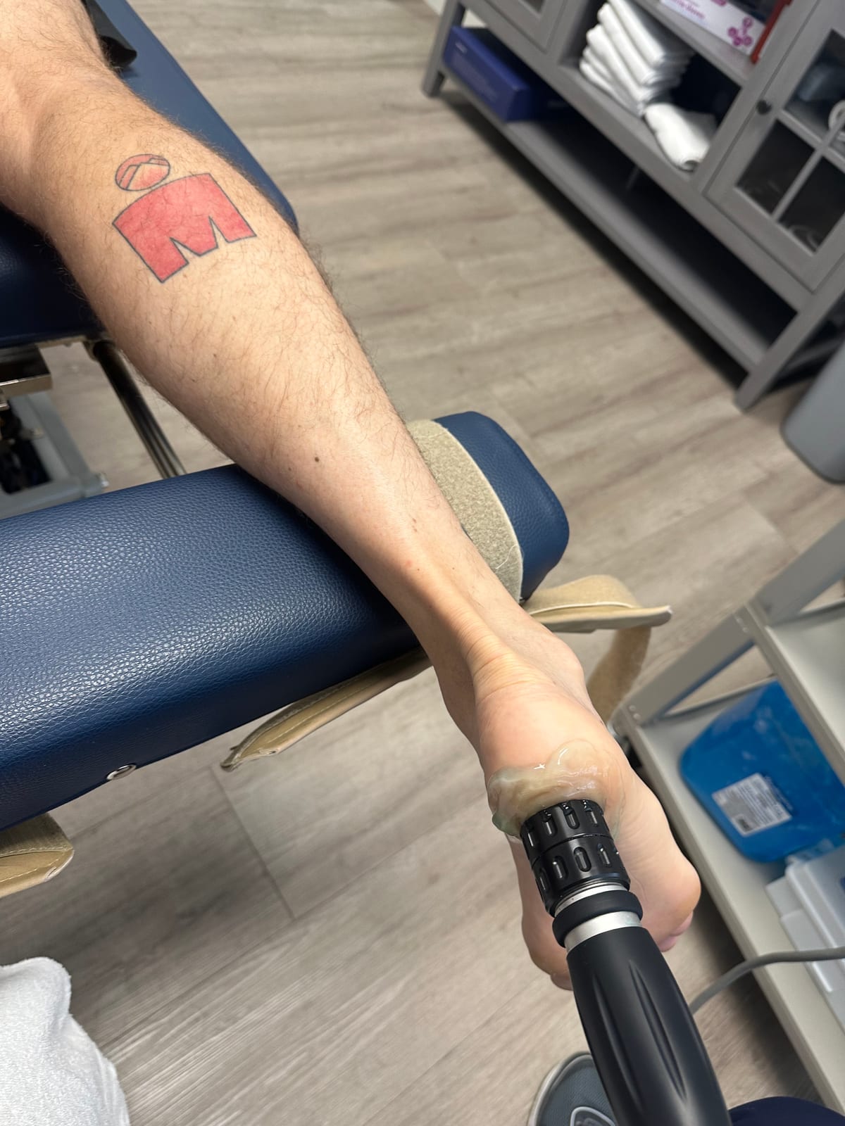 Shockwave therapy on the lower leg during a rehab session at Lakeside Sports Chiropractic + Physical Therapy